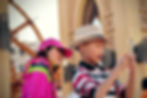 Two children at an amusement park engaging with a smartphone