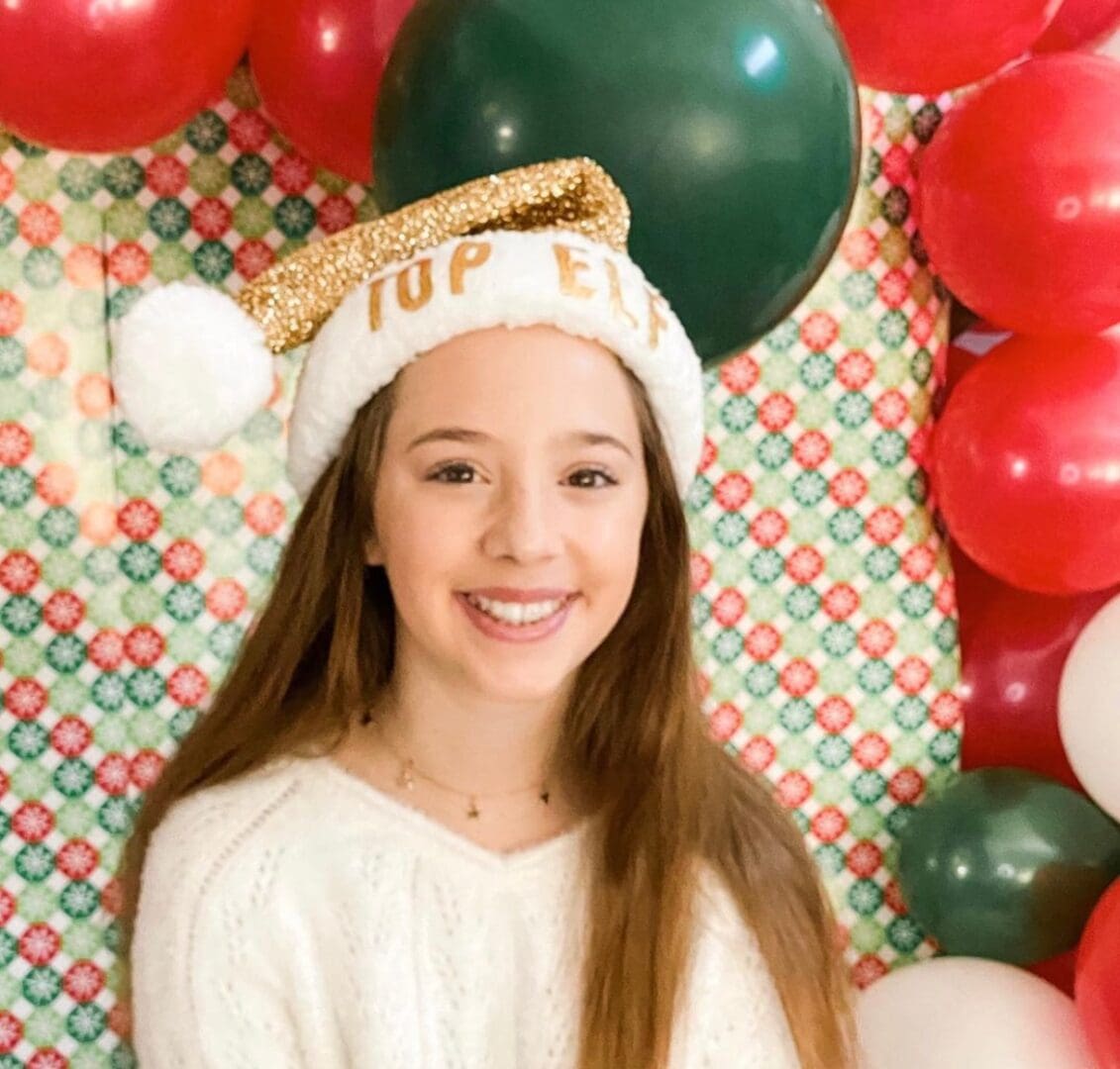 A girl wearing a top hat with the word " top " on it.