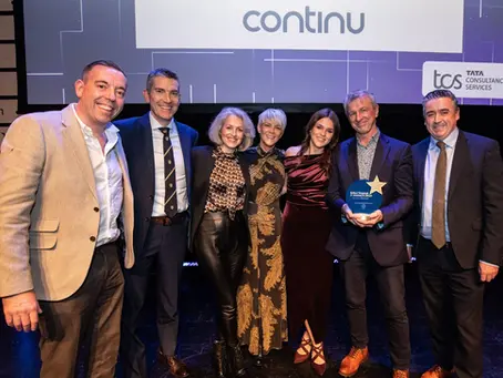 Team members holding IT Woman of the Year and IT Team of the Year awards at the Belfast Telegraph IT Awards in Belfast.