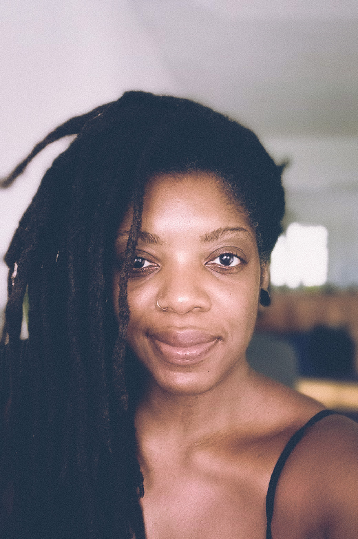 headshot of black woman with locs