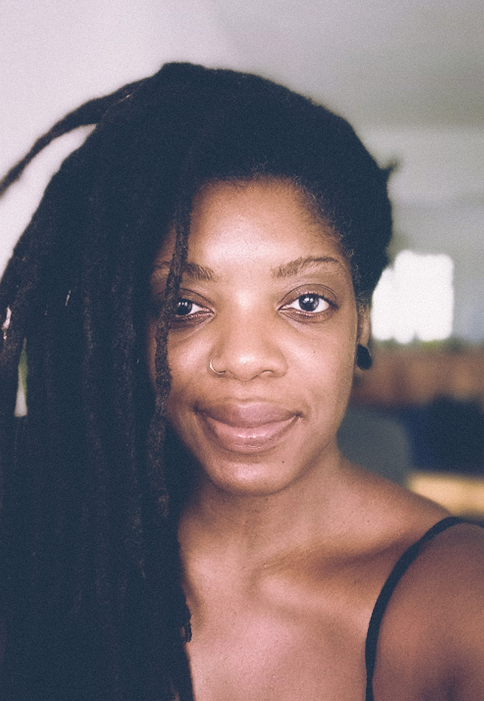 headshot of black woman with locs