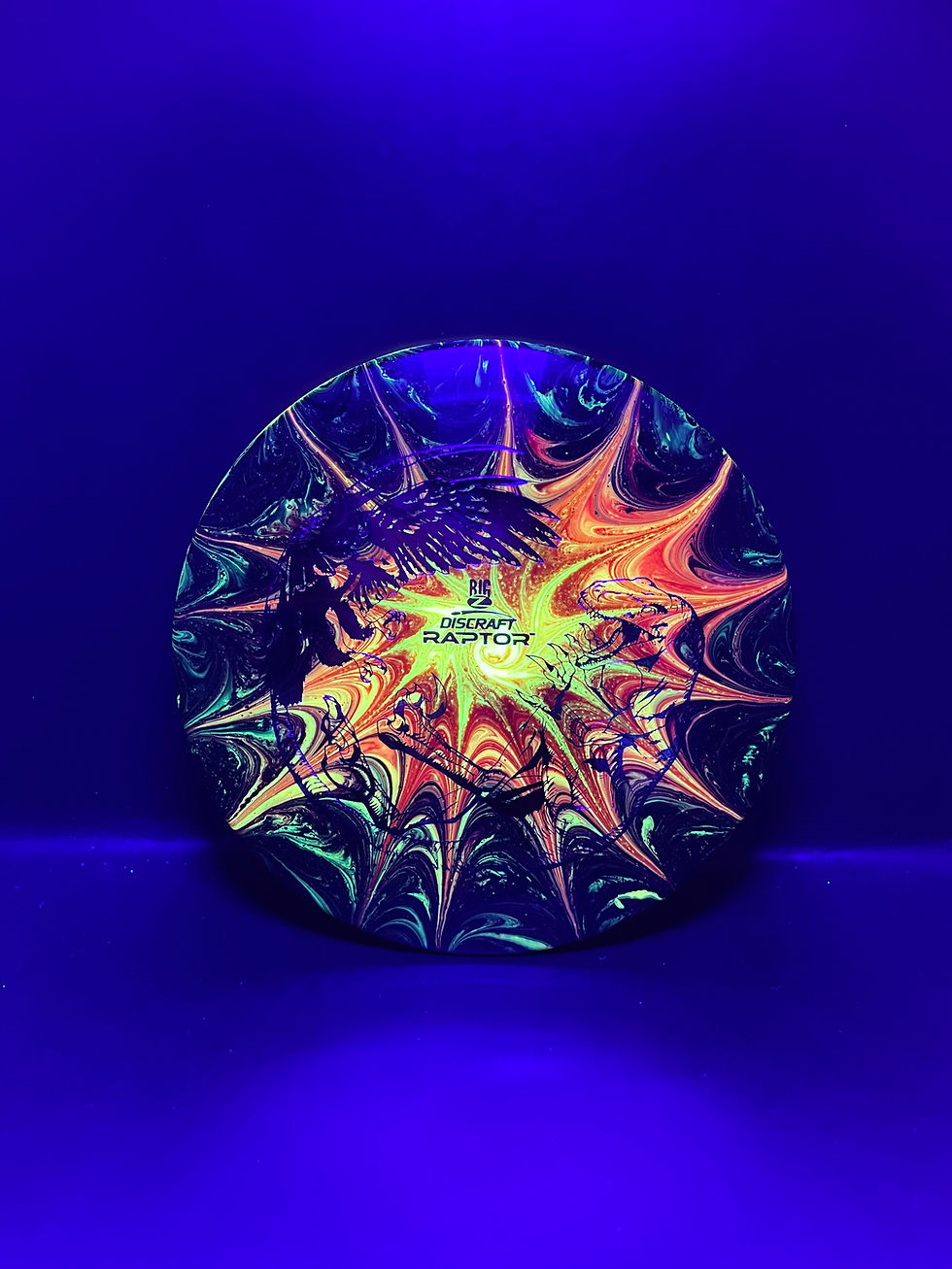 Thumbnail: Frontside Fiery Spiral Sunburst Raptor Mini under blacklight