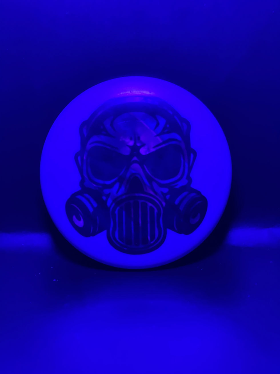 Frontside reddish purple gas mask mini under blacklight