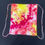 Thumbnail: Red, Pink and yellow tie dye in a unique pattern, front side of bag
