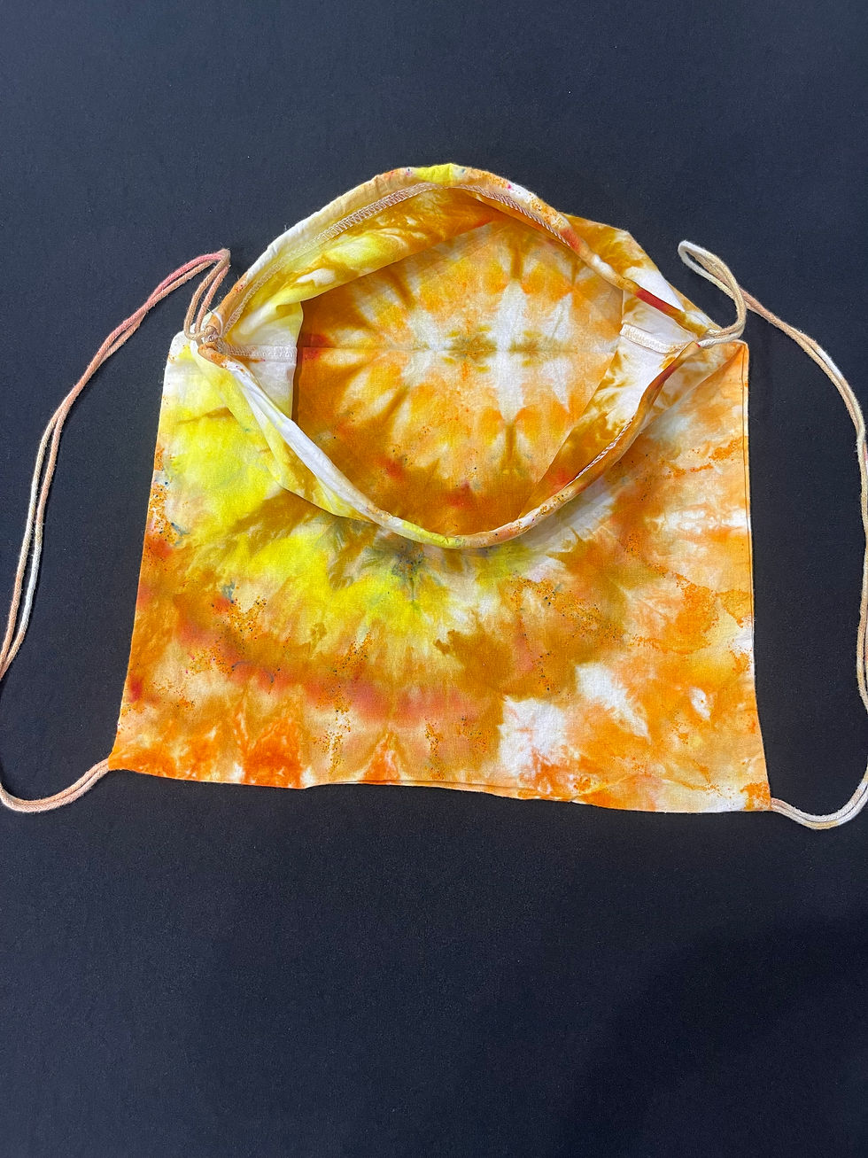Thumbnail: Brown, orange and yellow tie dye spiral open look