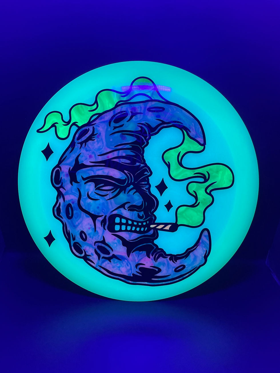 Frontside Smoking Magenta and Blue Crescent Moon Mamba under blacklight
