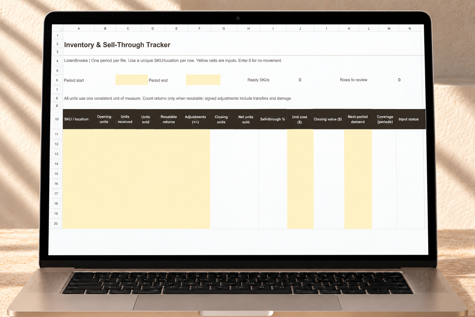 Inventory & Sell-Through Tracker worksheet displayed on a laptop in a warm neutral workspace