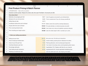 First Product Pricing & Batch Planner Excel worksheet on a laptop in a warm neutral workspace