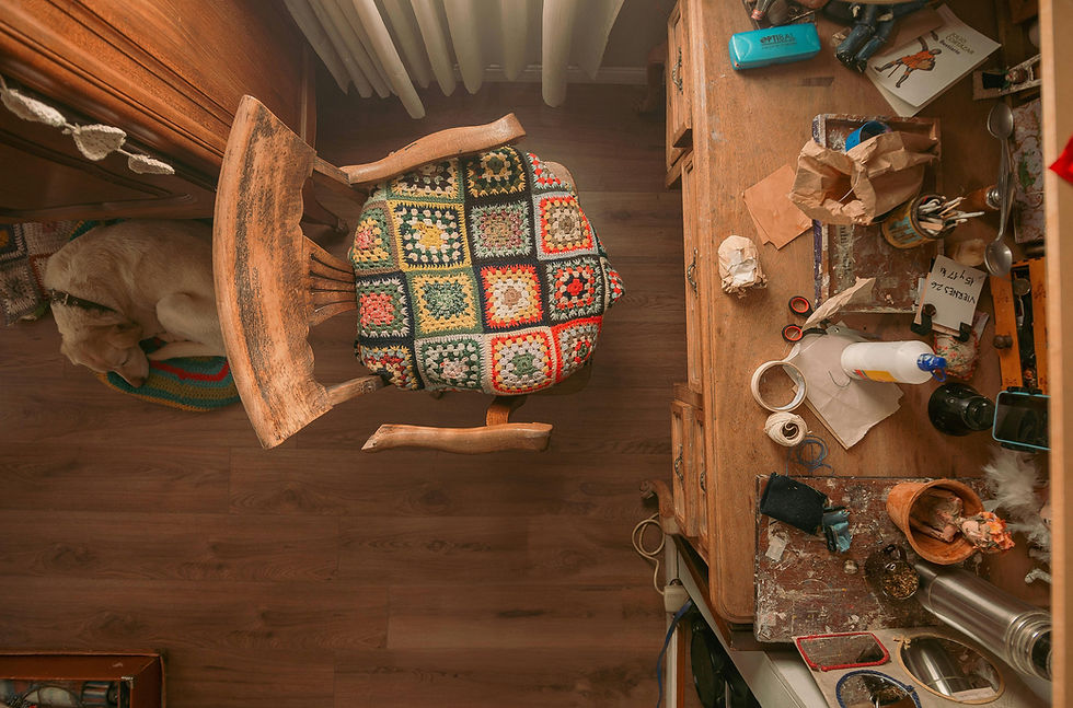 A top view of a work table, chair, and dog