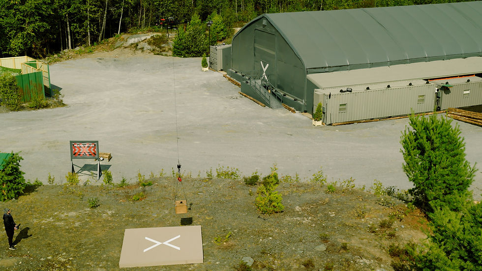 Aerial view of a drone delivering a package near a Extracted HQ building. 