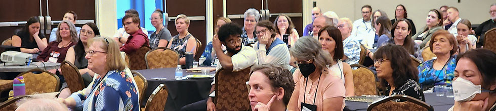 Writers and authors listen to a keynote address at the Quills Conference, a writing conference
