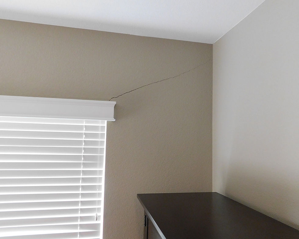 Drywall crack at window corner.
