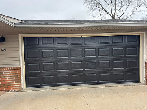 new short panel black color garage door installed