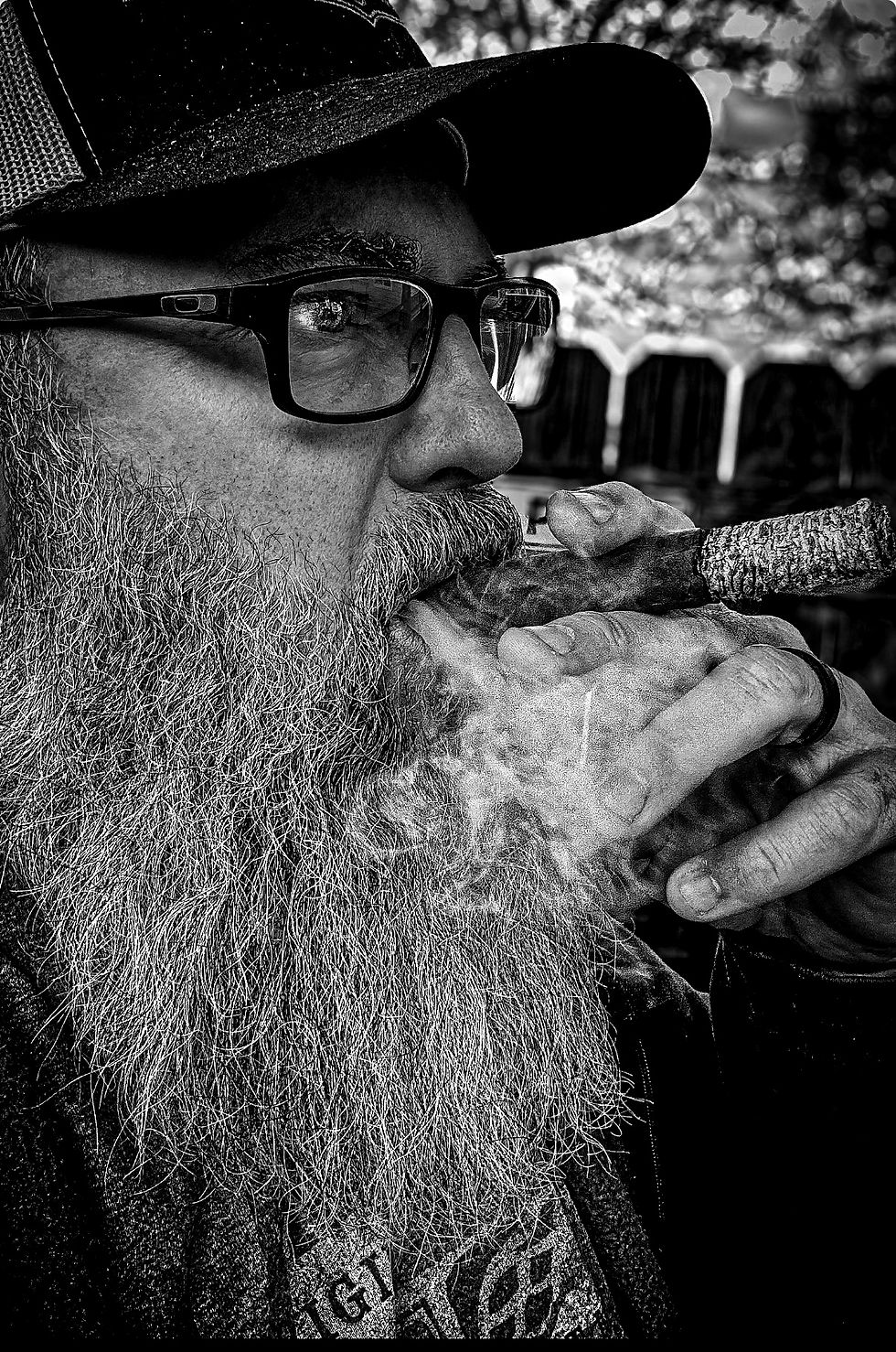 Bearded man smoking a cigar