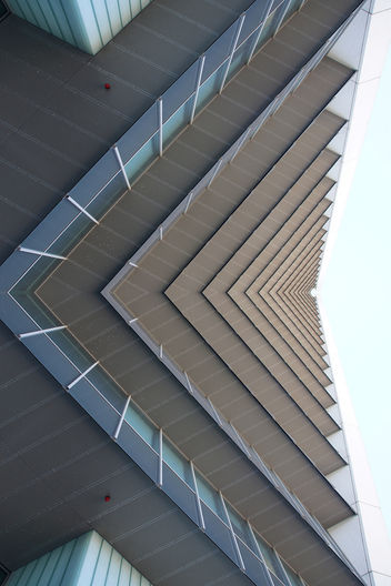 Looking up the facade of this beautiful symmetrical building, designed designed by Rudy Uytenhaak Architectenbureau: 'Stadsdeelkantoor Escamp' in The Hague, the Nederlands.