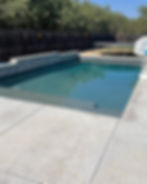 Custom swimming pool design with concrete patio