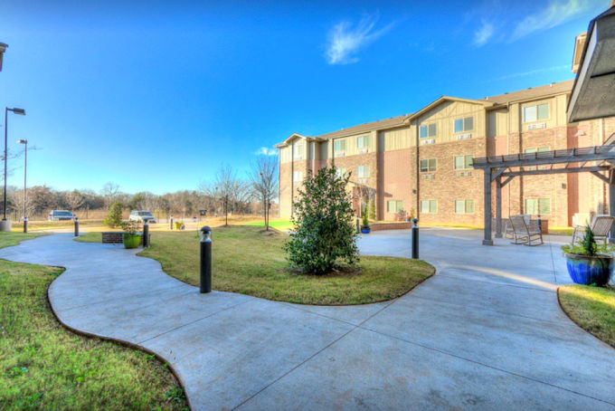Outdoor walking path and sitting area at Teal Creek Senior Living in Edmond, Oklahoma