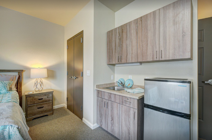 Photo of a studio room with kitchenette at Teal Creek Senior Living in Edmond, Oklahoma