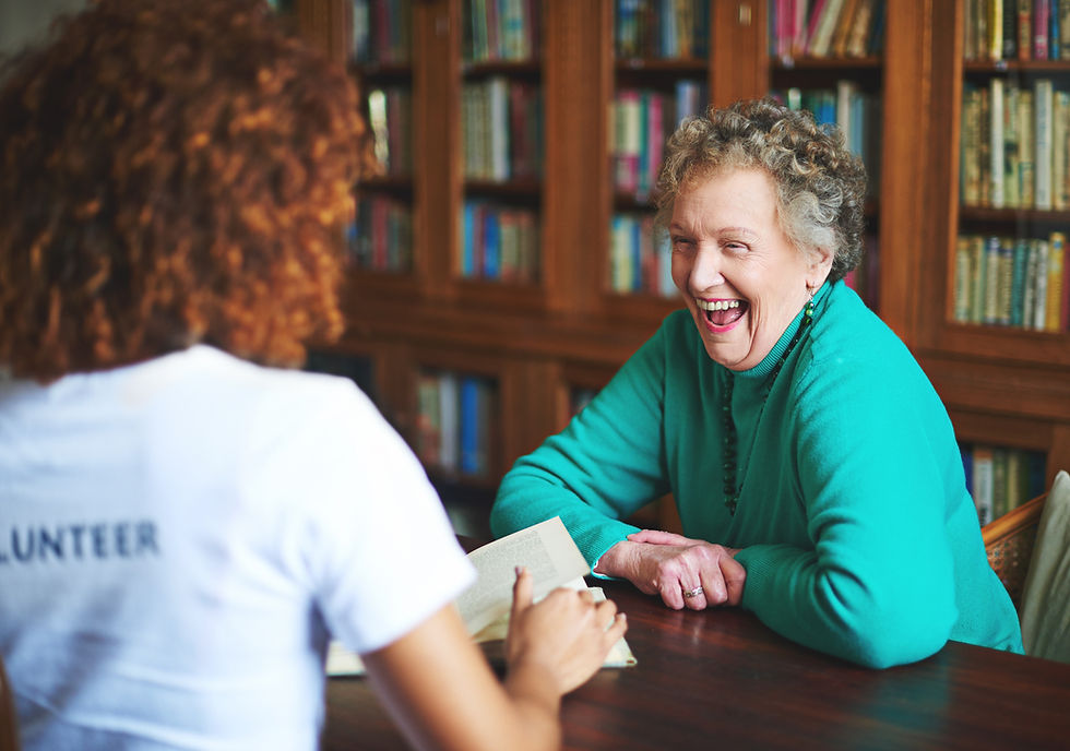 Senior resident at Omega Senior Living talking with a volunteer