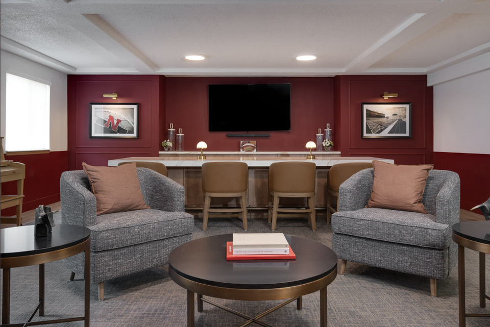 Beautifully renovated, cozy, and well-lit lounge and bistro bar with high ceilings, elegant fixtures, and comfortable seating at Kinship Pointe Seward