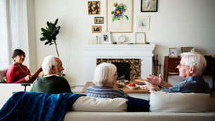 Seniors sitting on a couch in a senior apartment living room.