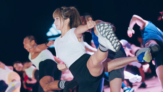 Instructor demonstrating a high kick during the Les Mills BODYCOMBAT 100 Asia Premiere