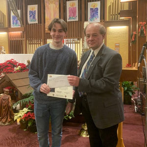 Presentation of scholarship by Deputy Grand Knight Doyle Rose (right) to recipient Nathan George (left).