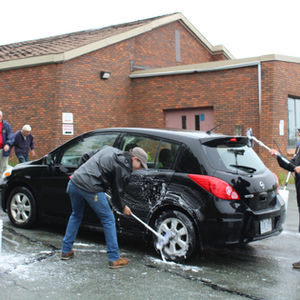 Men washing a vehicle