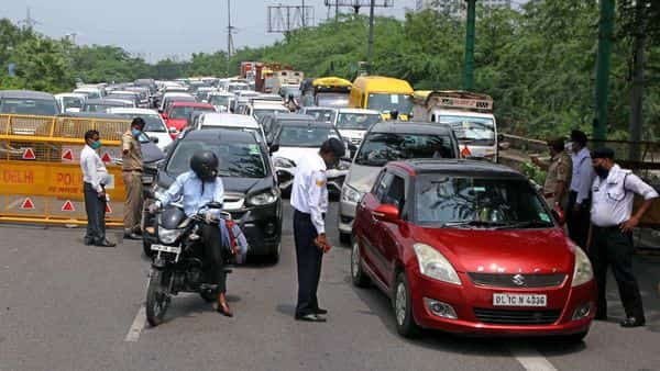 UP Police checking curfew pass for the entry in Uttar Pradesh at Delhi Noida border during the weekend lockdown in Noida.