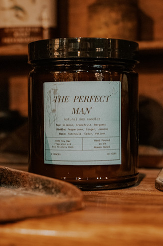 Rustic product photography of a handmade soy wax candle called "The Perfect Man."