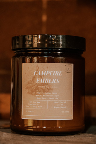 Rustic product photography of a handmade soy wax candle called "Campfire Embers."