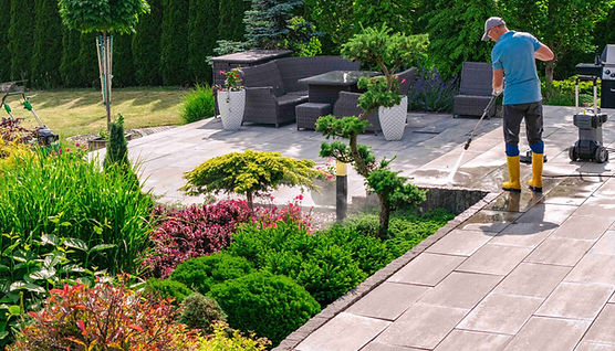 gardener-cleaning-patio-with-pressure-washer-wellmanicured-backyard..jpg