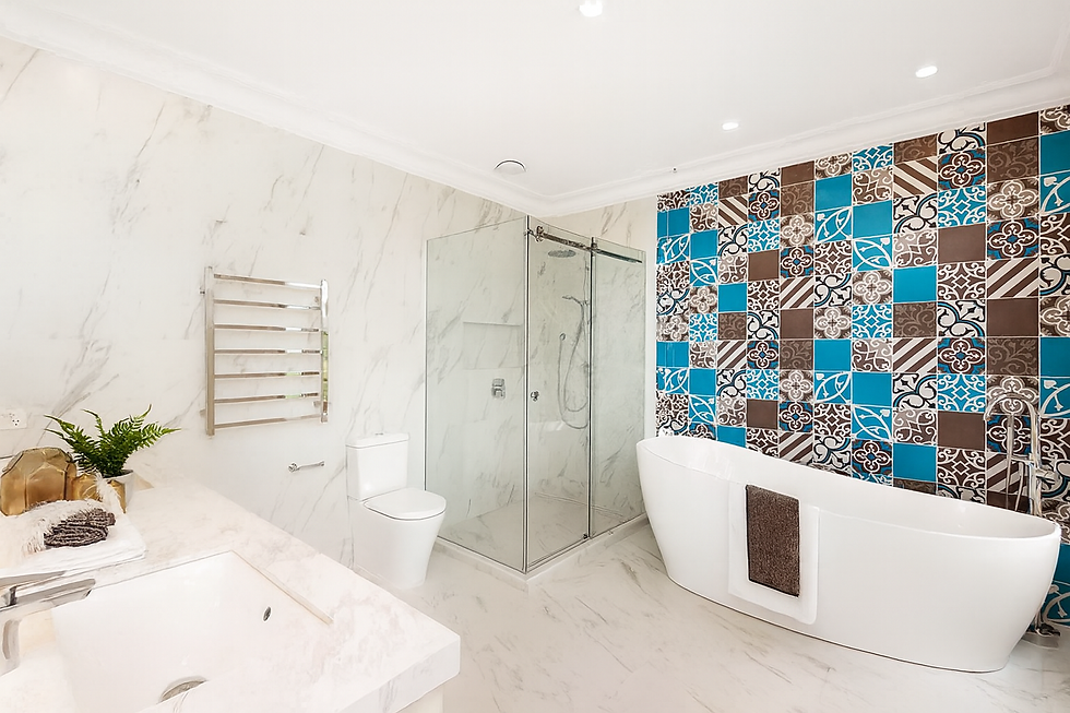 Bathroom with marble finishes, frameless glass shower, freestanding bath, and a bold featu