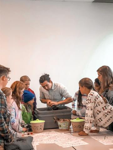Instructor showing students how to use compostable bins