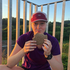 A desperate lady eating a sandwich