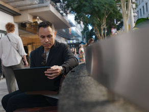 A man using a laptop in the city