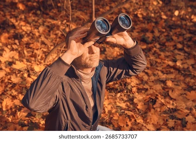 Scientist observing animals in the wild taking notes on behavior