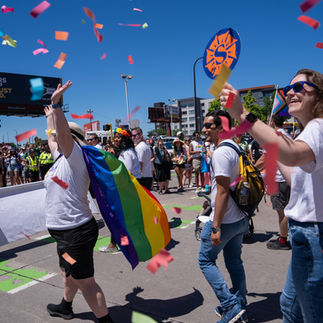 employees walking in the parade with confetti flying