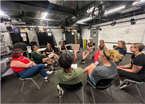 students in a circle learning from industry professional