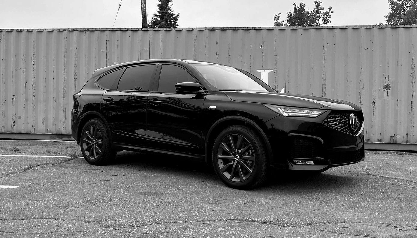 Black Acura SUV with tinted windows