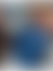 A newborn baby boy smiling up at his mom and dad.