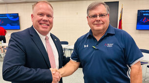 Dr. Hunnell shakes hands with Joel Shores