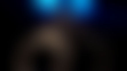 handcuffs in a dark room with blue lights in the background