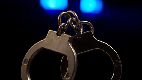handcuffs in a dark room with blue lights in the background