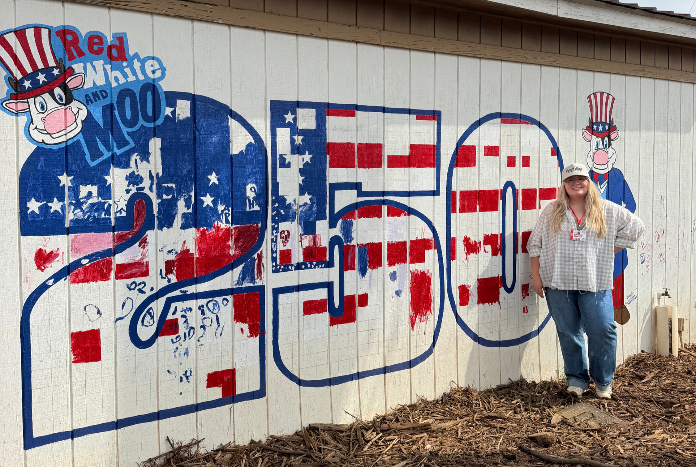 Bailey Jackson stands next to her community mural at the Fair. | Courtesy photo.