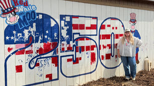 Bailey Jackson next to her mural at the Fair