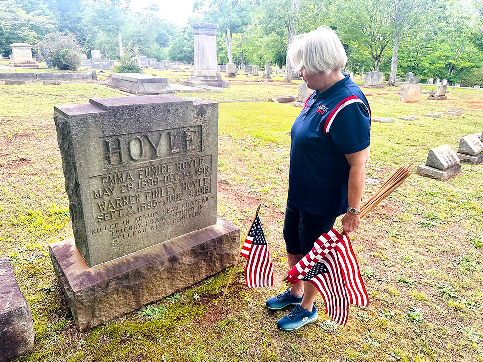 Martha Goodman Bridges stands in front of Warren F. Hoyle's memorial headstone. Hoyle was killed during The Great War, in 1918. His remains were buried in France.   | Chuck Thompson 