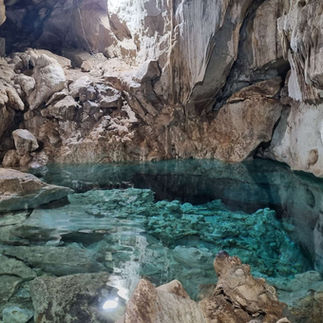 Small crystal-clear cenote in Yucatecan jungle