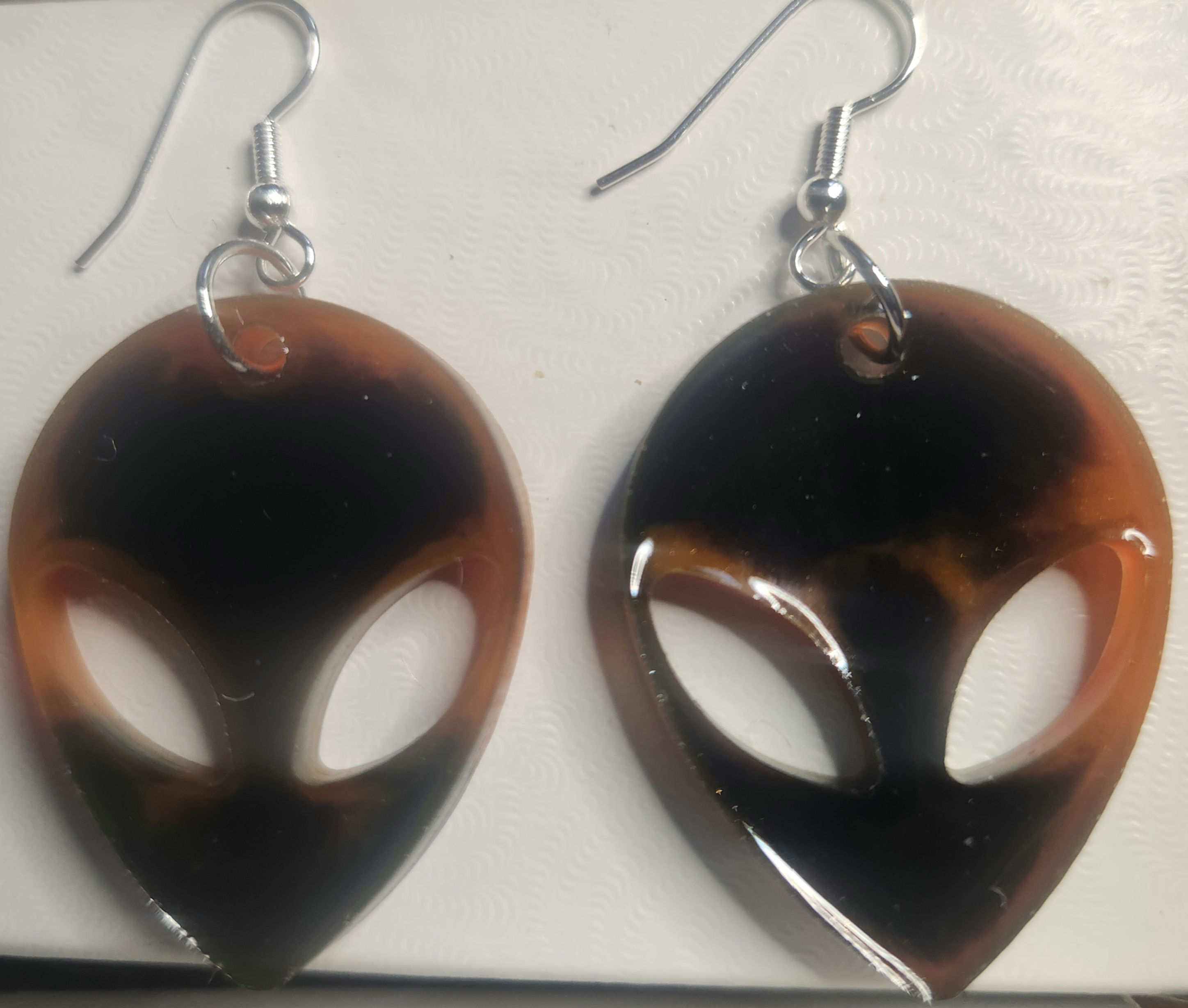 Red and black alien head earrings