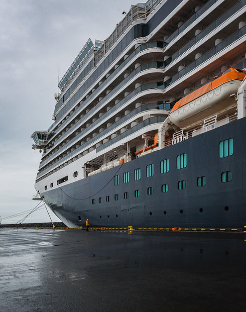 vertical-low-angle-shot-huge-cruise-ship-berthed-iceland-clear-sky.jpg